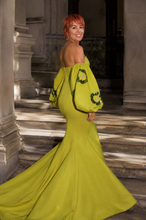 Load image into Gallery viewer, Woman wearing the Lunaria Couture Evening Gown in chartreuse featuring an off-the-shoulder neckline, voluminous sleeves with sequin floral appliqués, a fitted mermaid silhouette, and a floor-length train.