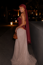 Load image into Gallery viewer, Back view of the Bordeaux Étoile Couture Gown showcasing the structured corset, flowing champagne skirt, elegant train, and matching chiffon head scarf.