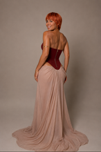 Load image into Gallery viewer, Back view of the Bordeaux Étoile Couture Gown showcasing the structured corset, flowing champagne skirt, elegant train, and matching chiffon head scarf.