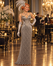 Load image into Gallery viewer, Silver Society floor-length Jazz Era gown featuring intricate Art Deco geometric beadwork, crystal embellishments and cascading silver fringe.