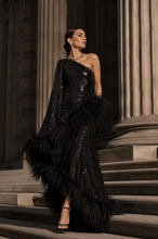Load image into Gallery viewer, Luxury black one-shoulder sequin evening gown with statement feather trim, fitted silhouette, and floor-length design for galas, black-tie events, and formal occasions.