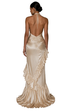 Load image into Gallery viewer, Back view of the Luxe Aurora Gown showcasing an elegant open-back halter design, sculpted satin silhouette, and cascading asymmetrical ruffles.