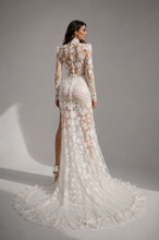 Load image into Gallery viewer, Back view of the Elysian Bloom Couture Gown showcasing illusion lace, floral embroidery, sheer long sleeves, elegant fitted silhouette, and flowing train.