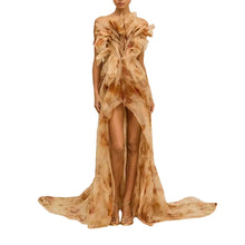 Load image into Gallery viewer, Model wearing the Soleia Couture Gown featuring sculptural ruffle details, a flowing high-low silhouette, watercolor-inspired floral print, and an elegant couture design for gala events, luxury occasions, and editorial fashion.